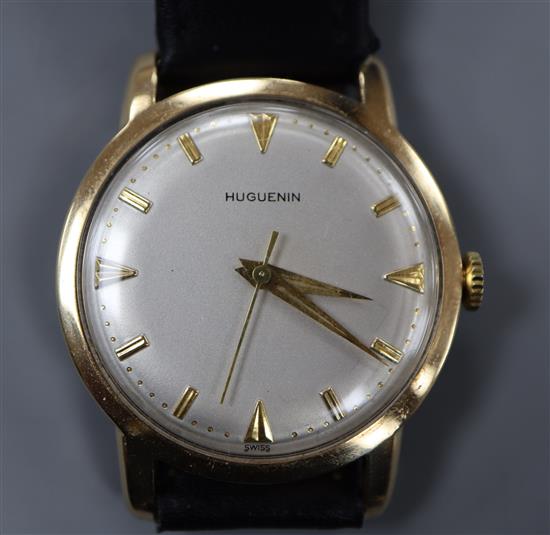 A gentlemans 14k Huguenin manual wind wrist watch, on associated leather strap.